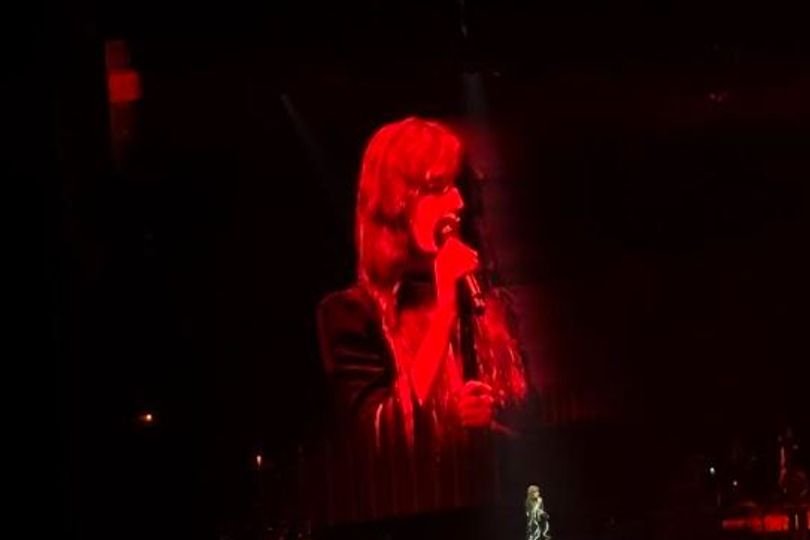 Florence & The Machine perform live in Liverpool, with the crowd singing along to every word, surrounded by a sea of colourful lights and energetic atmosphere, as the band's lead singer, Florence Welch, showcases her powerful voice and captivating stage presence