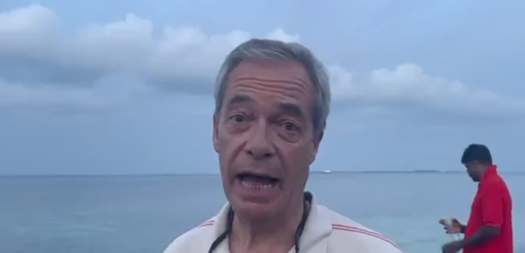 Aerial view of the Chagos Islands with crystal clear waters and coral reefs, highlighting the beauty of the islands despite the controversy surrounding them with Nigel Farage's involvement