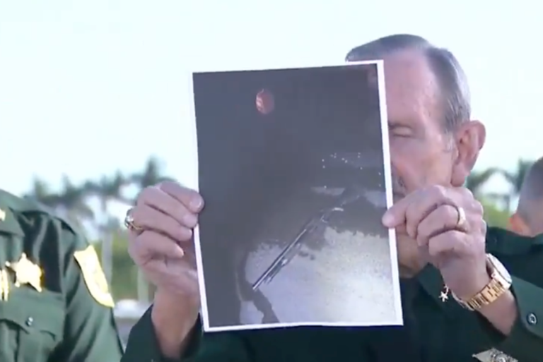 A photo of the Mar-a-Lago resort in Florida, with a sombre and reflective atmosphere, highlighting the tragic incident that occurred there, with a Trump supporter shot dead by police, and the family expressing their disbelief and shock, as they try to analyse the situation and come to terms with their loss