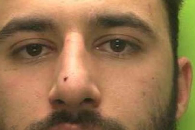 A police officer stands outside a Nottingham home, where a recent raid led to the arrest of a criminal set to be deported for the second time, highlighting the need for effective deportation laws to ensure public safety and prevent repeat offenders from re-entering the country