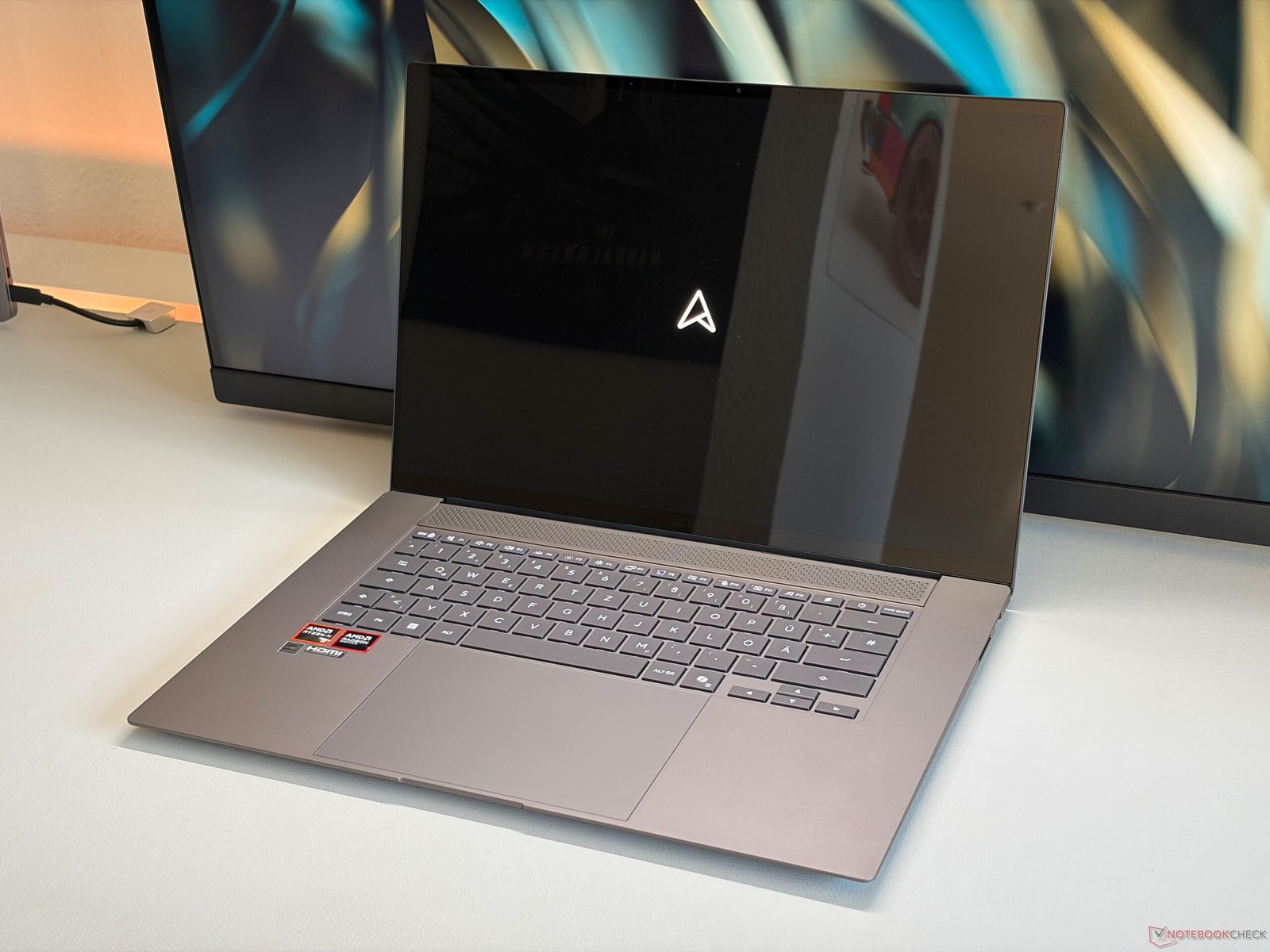The Asus Zenbook S16 with AMD Ryzen 400, showcasing its vibrant OLED screen and sleek design, perfect for work and leisure activities, with the primary keyword being Asus Zenbook S16