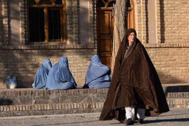 A woman in a burqa walks alone in a deserted street, symbolising the restrictive and oppressive nature of the Taliban's new penal code, which legalises domestic violence and puts husbands on par with 'slave masters', highlighting the need to support women's rights and condemn this draconian law