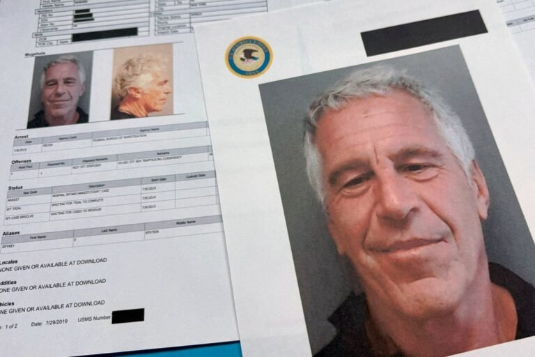 A photo of a person holding a file with a redacted section, symbolising the obscured release of the Epstein files, with a portrait of Elvis Presley and Marilyn Monroe in the background, highlighting the controversy surrounding the inclusion of their names