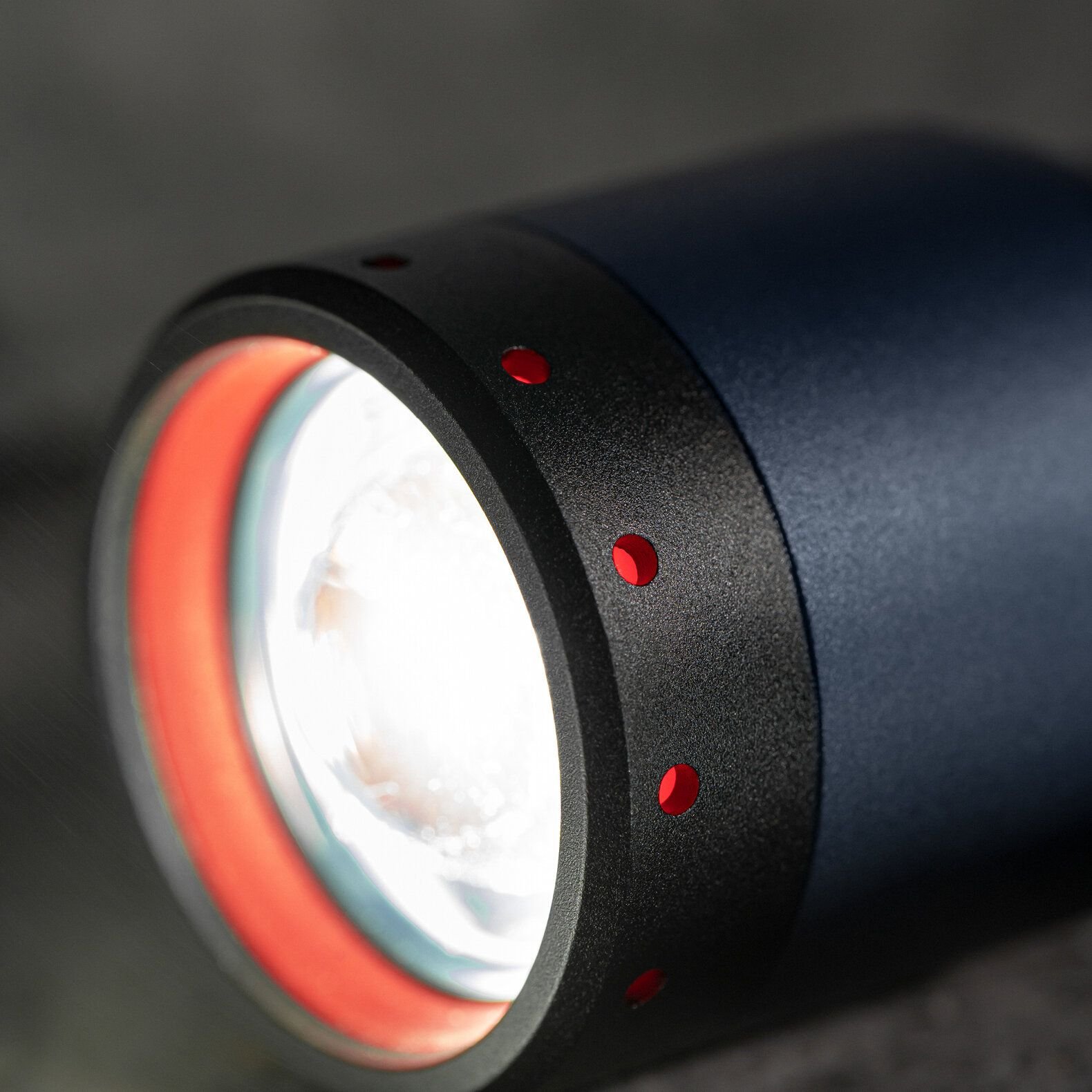 A close-up of a Ledlenser Photon Pump special-edition flashlight, showcasing its sleek design and advanced features, highlighting the company's 25-year commitment to innovation and quality in the LED flashlight industry