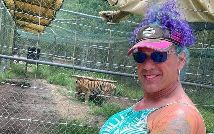A descriptive image of a mother and child at an ice hockey match, with a trans flag in the background, highlighting the primary keyword of trans father, in a colourful and supportive scene