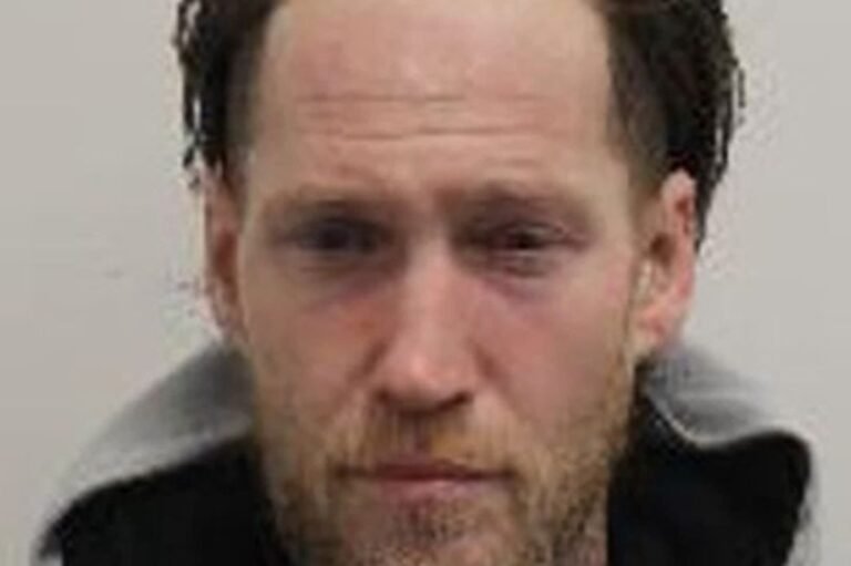 A photo of a Greggs bakery with a homeless person in the background, highlighting the issue of food theft and homelessness in the community, with a focus on the 'Hamster' incident