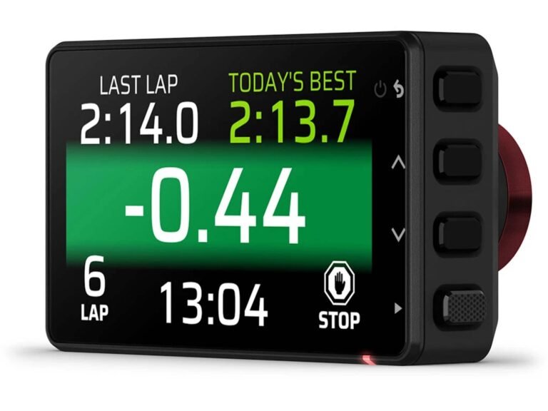 The Garmin Catalyst 2 device with a camera and display, mounted on a car's dashboard, with a blurred background of a racing track, showcasing its ability to capture high-quality video footage and provide real-time feedback to drivers