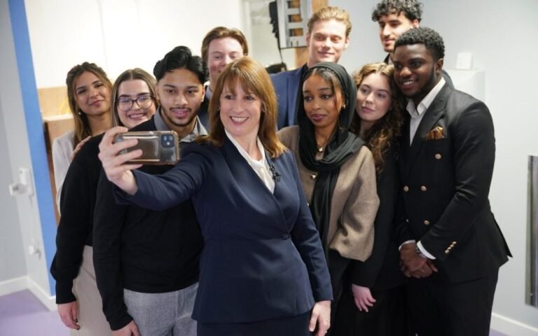 A group of young people in the UK, with a mix of emotions and reactions, as they consider the impact of Labour's youth minimum wage U-turn on their lives and futures, with a cityscape in the background, symbolising the urban environment and the economic reality of the UK's youth