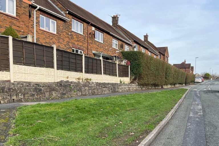 A couple sitting in their living room, looking frightened and shocked, with a burglar lurking in the background, demanding they drink a mysterious black liquid, highlighting the importance of home security and safety measures to prevent such incidents.