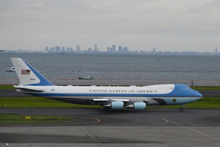 A photo of Air Force One with a new colour scheme, featuring a blue and white design with gold accents, representing the US military's new visual identity and Trump's preferred colours