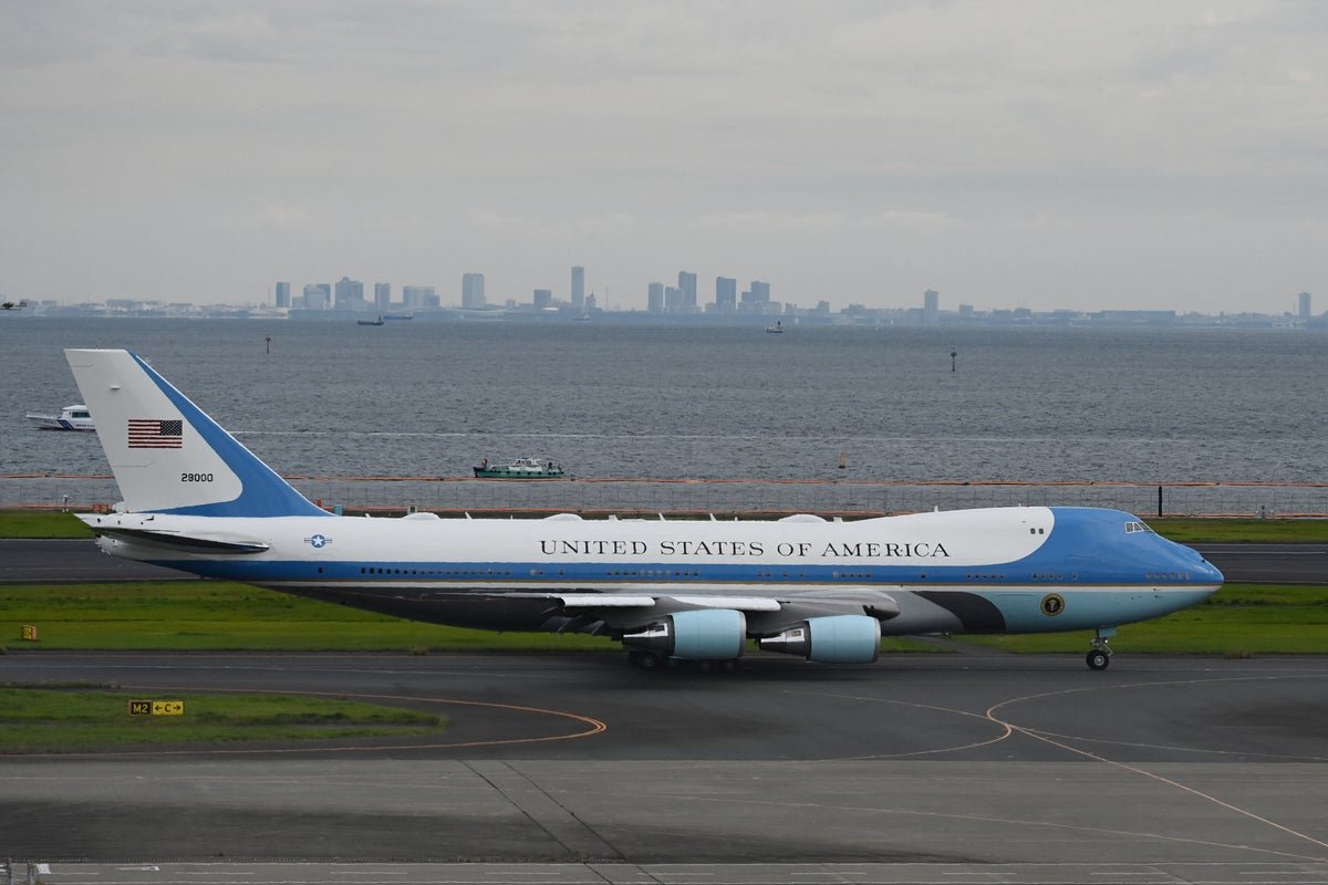 A photo of Air Force One with a new colour scheme, featuring a blue and white design with gold accents, representing the US military's new visual identity and Trump's preferred colours