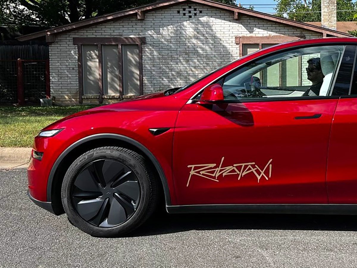 A Tesla Model Y robotaxi is seen driving on a busy street, with a caption that reads 'Tesla Model Y robotaxi accidents are on the rise, with the unsupervised fleet experiencing accidents at a higher rate than human drivers, the primary keyword phrase is robotaxi accidents'
