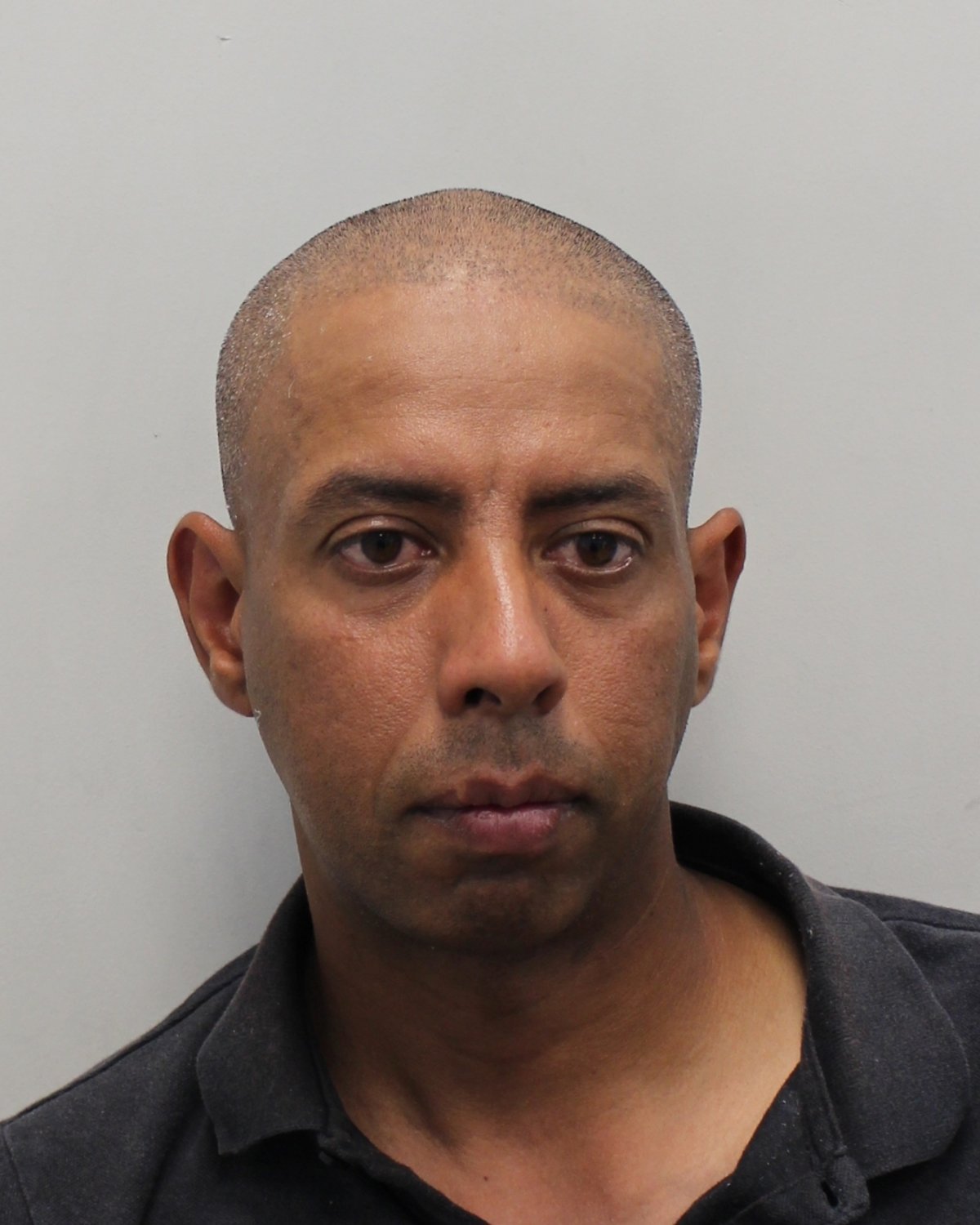 A photo of a London hotel with a police car outside, highlighting the Met Police investigation into an alleged serial predator who targeted a victim by pretending to be an injured sportsman, raising concerns about public safety and the need for awareness