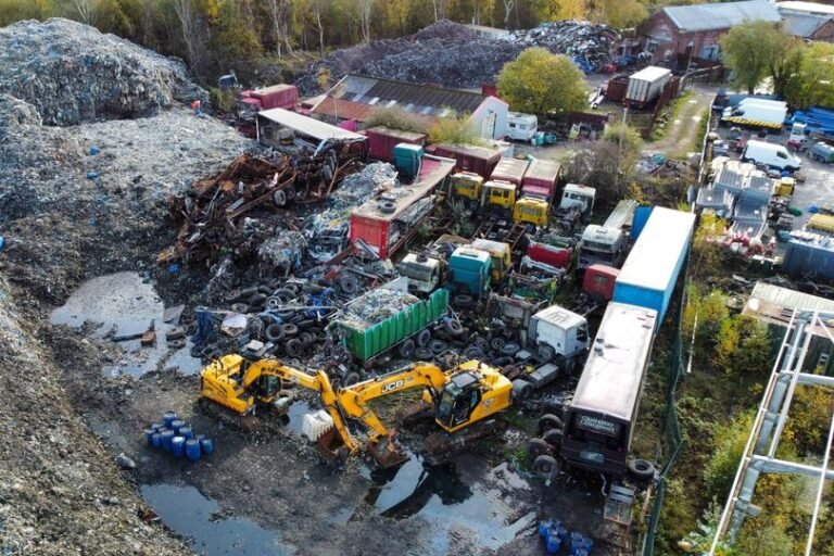 A pile of illegally dumped waste in a rural area, with a bulldozer in the background, highlighting the scale of the problem and the need for effective waste management solutions, with a focus on bulk waste disposal