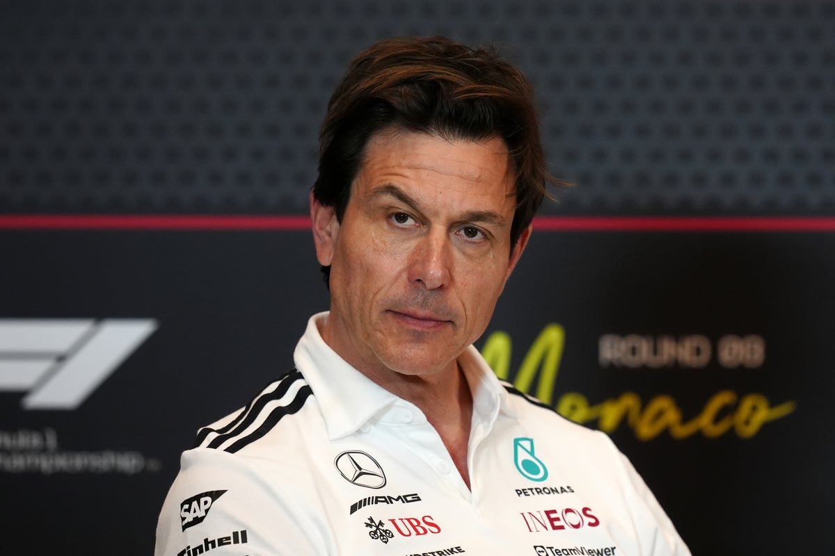Toto Wolff speaking at a press conference, with a mixture of shock and outrage on his face, amidst the Mercedes controversy in the F1 paddock