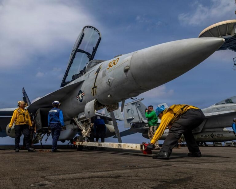 A dramatic image of the Iranian flag waving in the wind, with a subtle background of the US flag, symbolising the escalating tensions between the two nations, with the primary keyword Iran war featured prominently