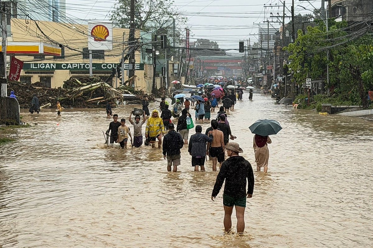 Aerial view of flooded areas in the Philippines, with rescue teams and emergency services working to provide aid and support to affected communities, amidst the devastating impact of torrential rain and landslides
