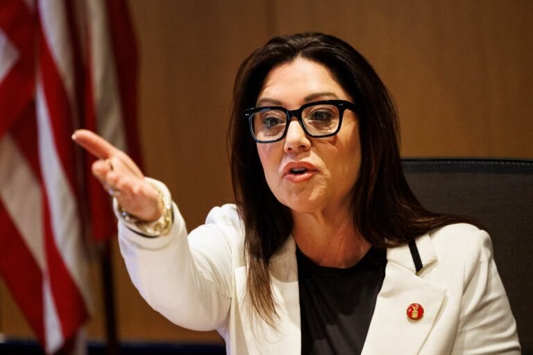 A photo of a person standing in front of a government building, with a caption that reads 'Sexual assault allegations against Trump's Labor Secretary's husband have sparked a heated debate about accountability and justice', featuring the primary keyword 'sexual assault allegations' naturally