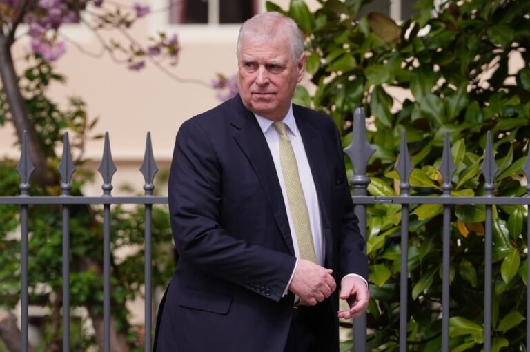 Prince Andrew, the Duke of York, standing in front of the Royal Lodge, with a mix of concern and determination on his face, as he challenges his removal from the residence, with the Royal Family's crest and colours prominently displayed in the background, symbolising the institution's rich history and tradition.