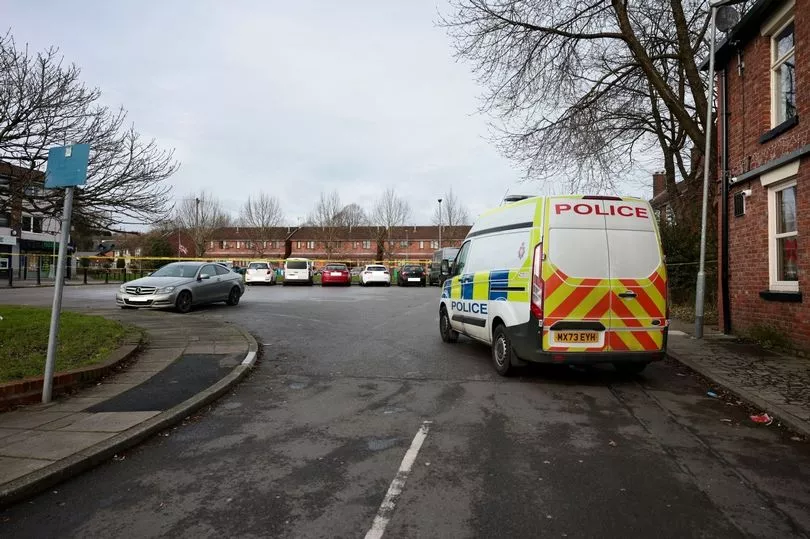 Car park attack scene with police and ambulance