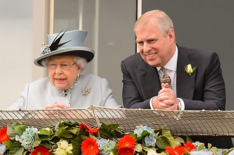 A photo of the royal family with a subtle hint of controversy in the background, with the royal footman in question standing near Andrew, sparking a heated debate about the behaviour of the royal family and their staff, with a mix of colour and drama