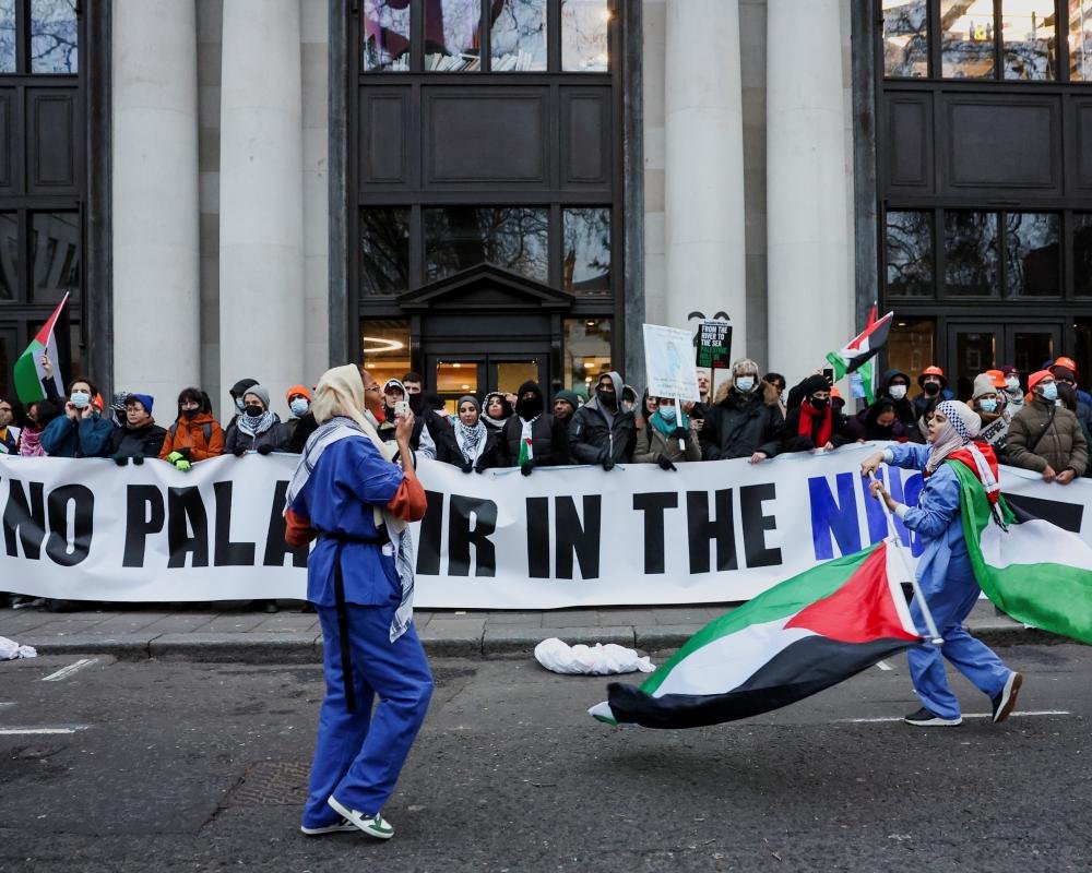 A person holding a tablet with a concerned expression, surrounded by circles and lines representing data collection and surveillance, with the Palantir logo in the background, highlighting the company's involvement in data analytics and the potential risks to UK citizens' data rights