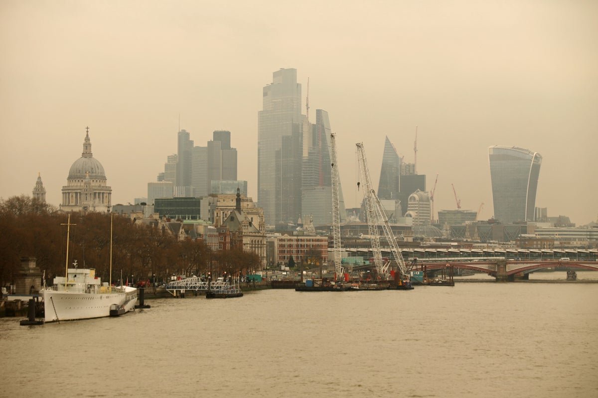 A dramatic landscape photo of a stormy sky with reddish hue, capturing the essence of 'blood rain' as Saharan dust cloud approaches the UK, with the primary keyword 'blood rain' naturally included