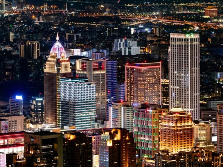 A graphic illustration of the global economy, with a focus on the China-Taiwan region, highlighting the potential economic risk and crisis tied to the escalating tensions between the two nations, with a subtle background image of a stock market screen displaying volatile market behaviour