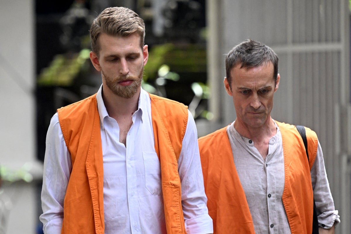 A descriptive image of a Bali court where two British men were jailed for cocaine smuggling, highlighting the primary keyword phrase of cocaine smuggling and the severity of the crime, with a focus on the behaviour of the men and the colour of the Indonesian flag