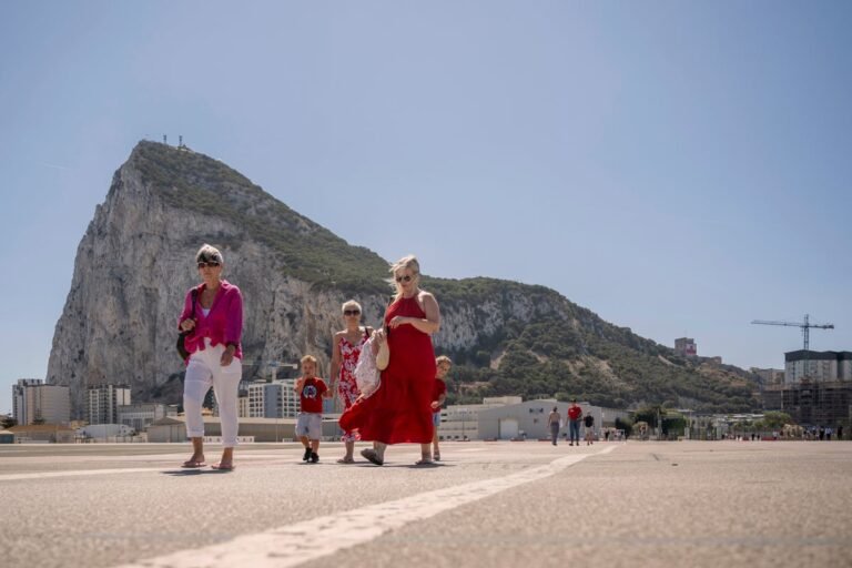 Aerial view of Gibraltar with a plane flying overhead, symbolising the new passport control measures for Brits travelling to the region under the post-Brexit deal, with a focus on travel regulations and border control