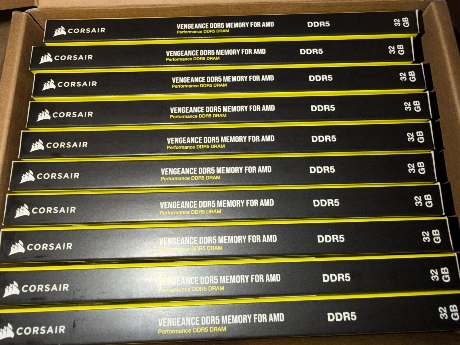 A photo of a person holding a stack of memory kits with a surprised expression, highlighting the unexpected RAM jackpot, with a background of computer hardware and Amazon packaging