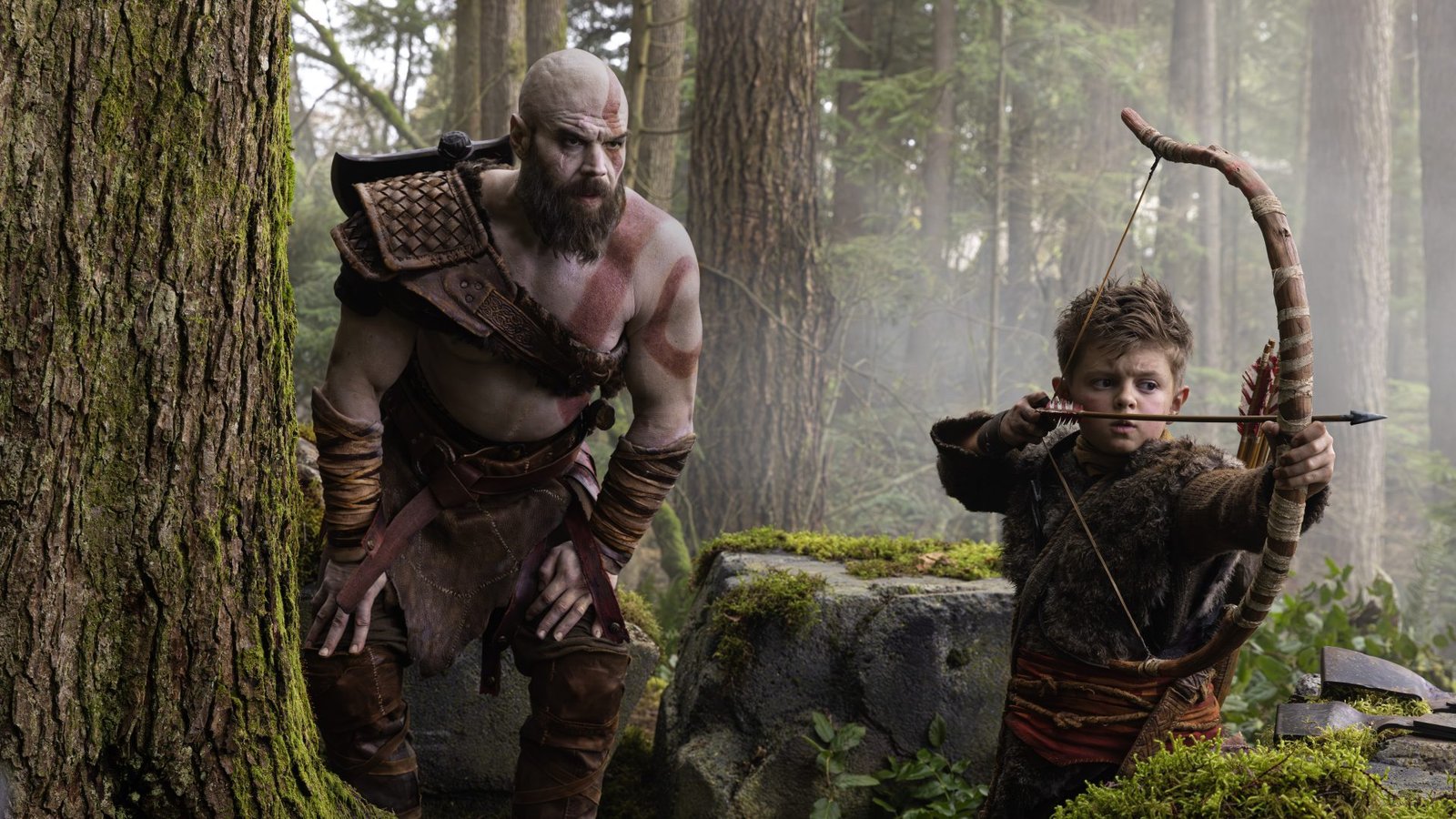 Kratos and Atreus stand together, ready for battle, in a scene from the God of War TV series, showcasing the intricate costumes and detailed environments, with a focus on the primary keyword, God of War TV series, in the UK production