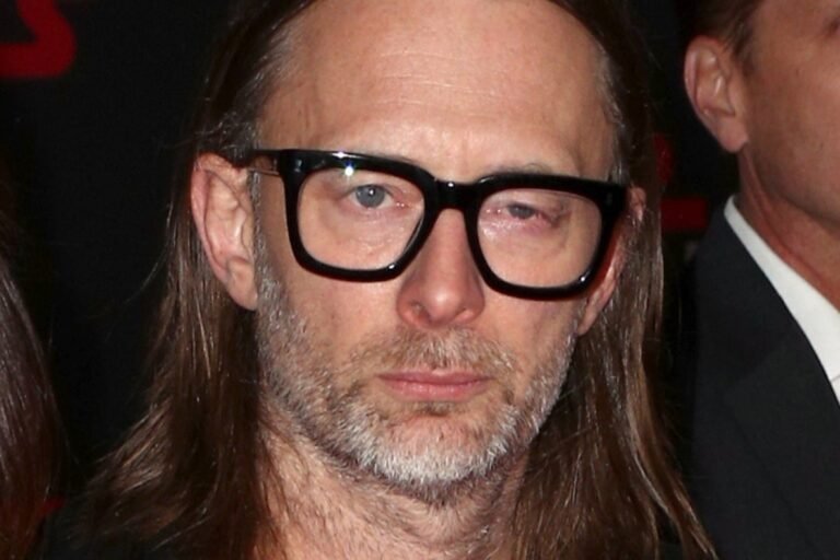 Radiohead's music at the centre of ICE controversy, featuring a descriptive image of the band's lead singer, Thom Yorke, with a concerned expression, highlighting the primary keyword 'Radiohead'
