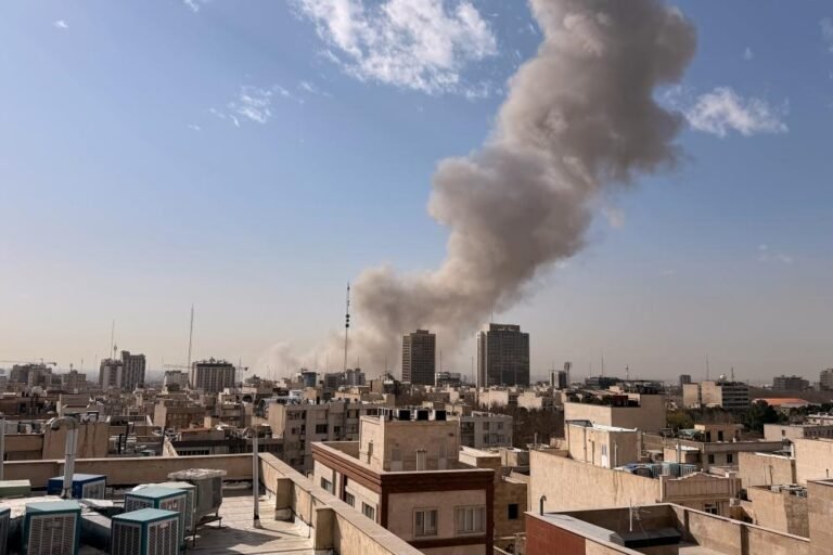 Explosions rock Tehran as Israel launches airstrike on Iran, with smoke billowing from damaged buildings and debris scattered across the streets, highlighting the primary keyword of Middle East conflict