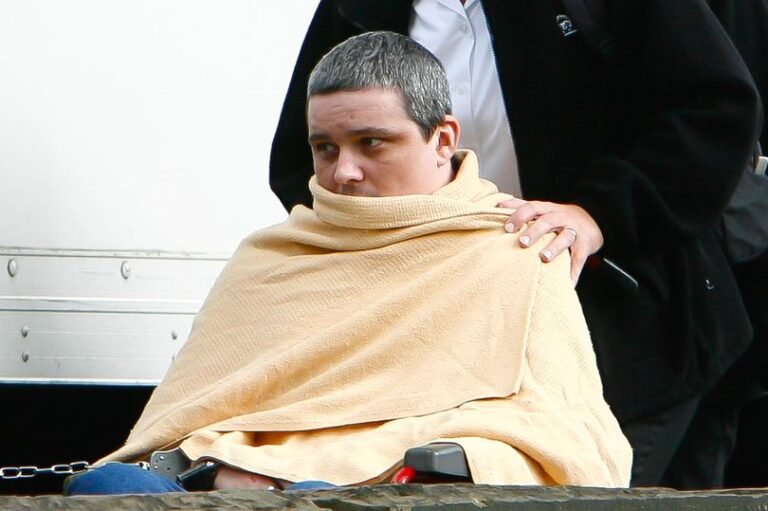 A photograph of Ian Huntley, the Soham killer, with a sombre expression, highlighting the seriousness of the prison attack and the ongoing impact of the Soham murders on the community, with a focus on the primary keyword phrase Soham killer