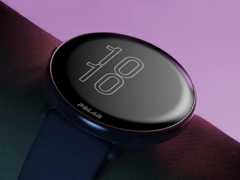 A close-up of a Polar smartwatch on a user's wrist, showcasing the device's sleek design and vibrant colour display, with a focus on the improved battery life and performance in the UK market