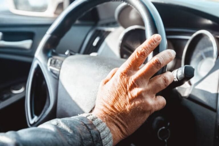 An elderly driver behind the wheel, with a concerned expression, highlighting the debate about road safety and driving restrictions for over-80s, with a focus on licence restrictions and elderly driving