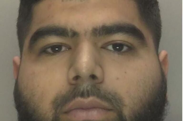 A descriptive image of a busy Birmingham street at night, with a nightclub in the background, and people walking in all directions, highlighting the primary keyword of Birmingham nightlife