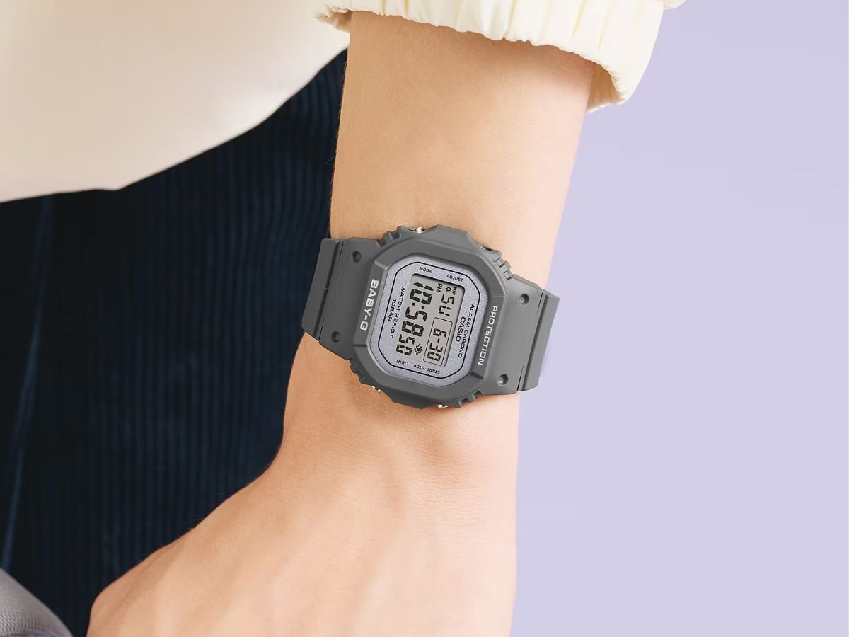 A close-up of a Casio square-shaped digital watch with a pearlescent dial and colorful display, showcasing the watch's sleek design and features