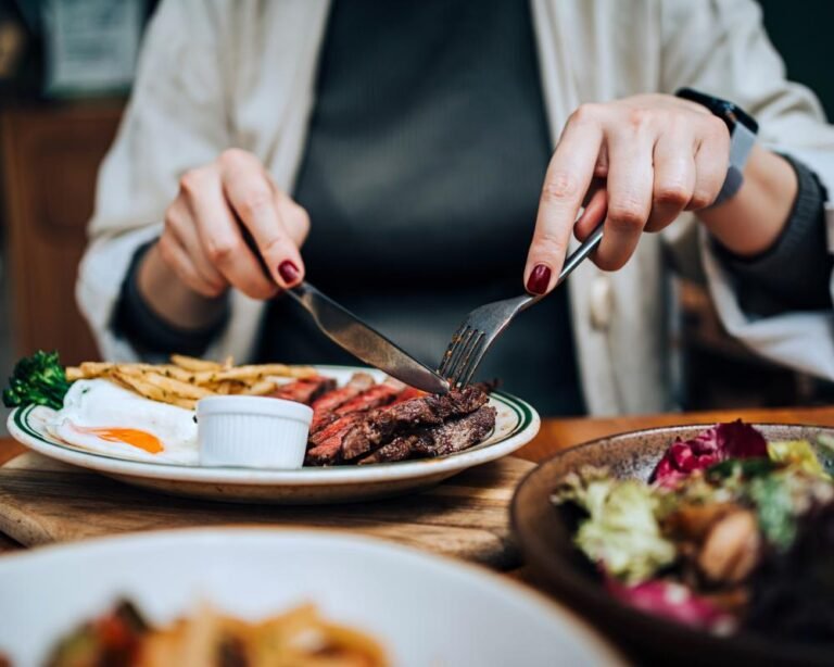 A woman in her 40s exercising outdoors, highlighting the importance of physical activity in reducing the risk of breast cancer, with a beautiful landscape in the background, symbolising a healthy and active lifestyle, and a positive approach to cancer prevention