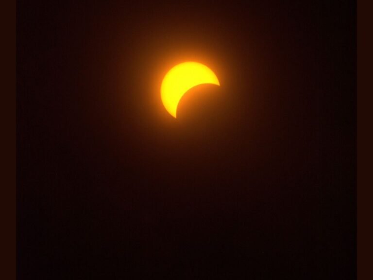 A total solar eclipse is seen from the United States, with the sun's corona visible as a glowing halo around the dark disk of the moon, showcasing the beauty of astronomical phenomena in the UK and beyond, with the Eclipse Megamovie project