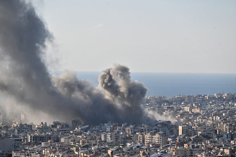 Aerial view of a popular British holiday destination, with a backdrop of chaos and disruption, as explosions and flight cancellations cause widespread concern, and the primary keyword 'holiday chaos' is evident in the scene