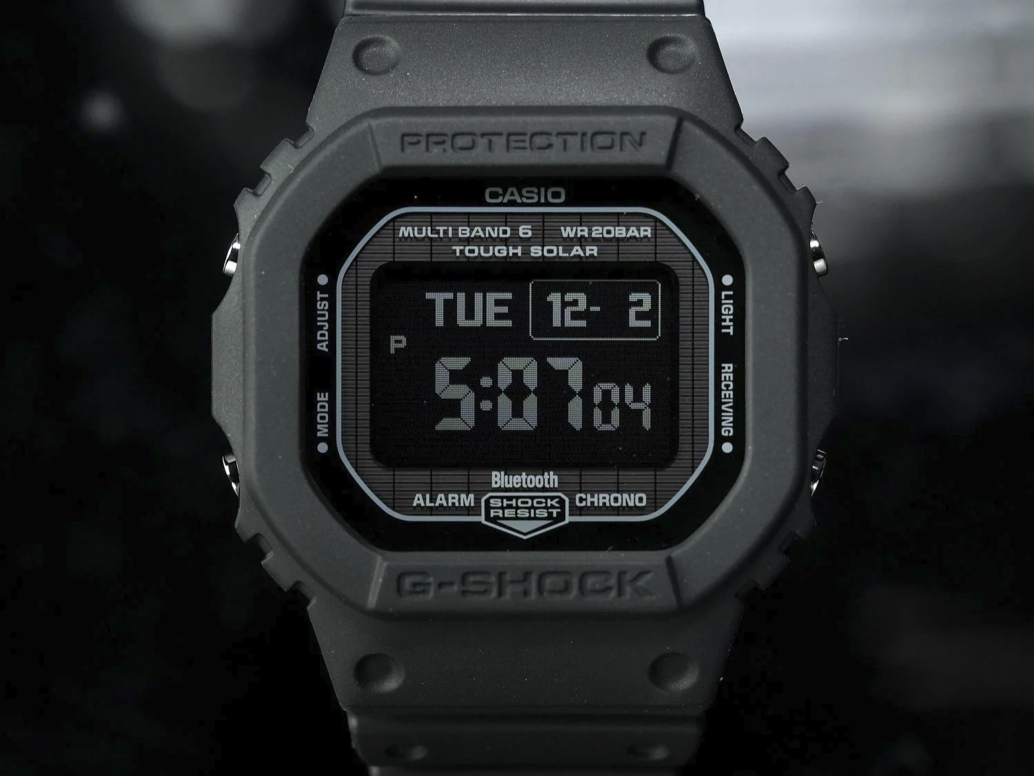 The G-Shock GW-BX5600CB-2JR watch with a gray case and blue fabric strap, showcasing its MIP LCD display and Tough Solar system, perfect for watch enthusiasts in the UK