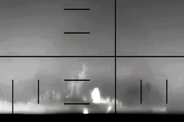 A US submarine is seen in the distance, with a Iranian warship in the foreground, as the two vessels engage in a deadly confrontation off the coast of Sri Lanka, highlighting the primary keyword phrase US submarine attack