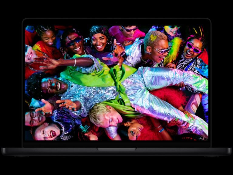 A person holding a MacBook Air with an M5 processor, showcasing the device's improved performance and features in the UK