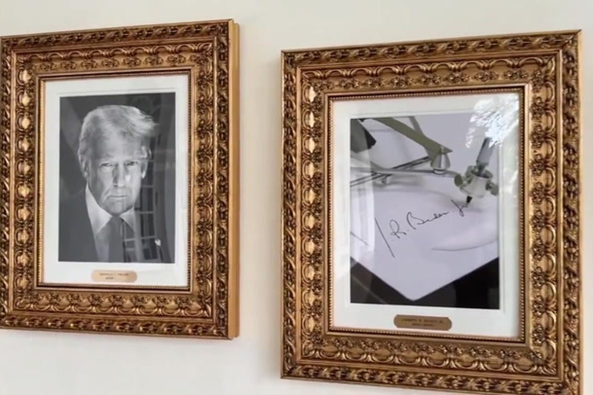 Joe Biden using an autopen to sign a document, a common practice among politicians, with a serious expression, analysing the behaviour of his opponents, and the colour of the room is a bright white, as he is surrounded by his team