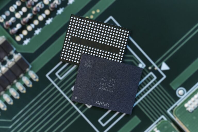 A close-up of a circuit board with NAND flash memory chips, with a graph showing the rising prices in the background, highlighting the impact of the NAND crisis on the UK tech industry