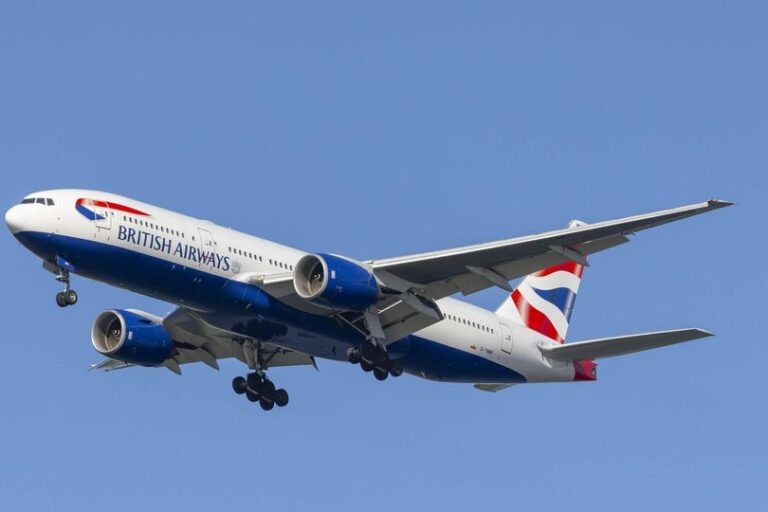 A stunning landscape of Ha Long Bay in Vietnam, with a beautiful boat sailing through the calm waters, surrounded by lush green trees and towering limestone cliffs, highlighting the country's unique natural beauty and the importance of respecting local customs and laws when travelling abroad