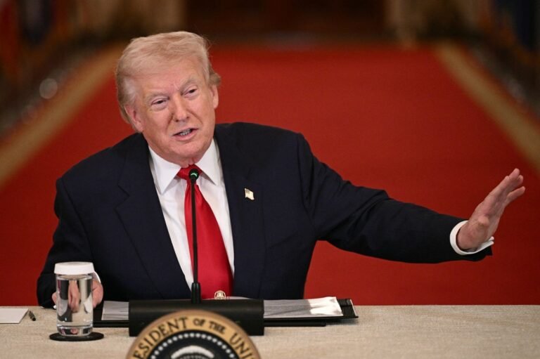 Donald Trump speaking at a press conference, with a serious expression, as reporters look on, with the American flag in the background, and a caption that reads 'Trump Speaks Out on Claims of Russian Aid to Iran'