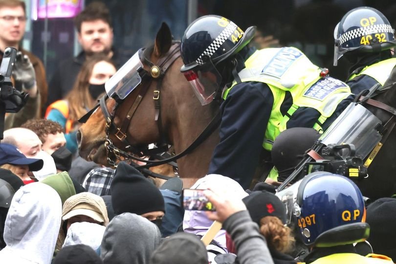 A descriptive image of protesters and police in Bristol, with a focus on the anti-racism protests and the need for peaceful coexistence, as people from all walks of life gather to express their views and promote unity